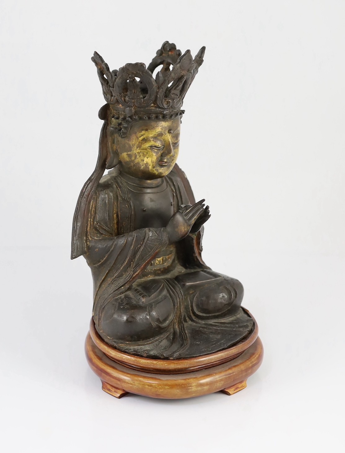 A Chinese late Ming bronze seated figure of Guanyin, 29.5cm high